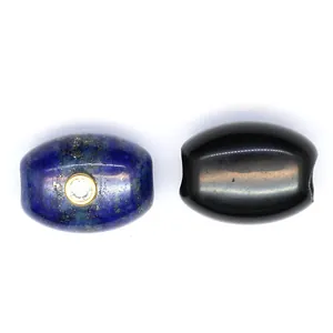 Detailed view of blue lapis lazuli and black onyx barrel beads with zircon inlay