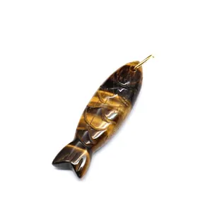 Detailed view of hand-carved tiger's eye stone fish pendant with intricate scales