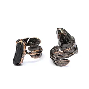 Close-up of vintage feather open rings featuring natural black tourmaline raw stones