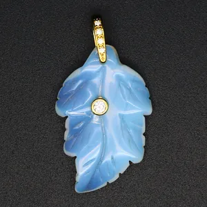 Macro shot of a carved light blue Amazonite leaf pendant with sparkling zircon detail