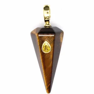 Macro view of hexagonal Tiger's Eye stone pendant with embedded yellow teardrop gem
