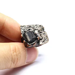 Detailed view of a vintage bronze-finished open ring featuring a raw black crystal stone.