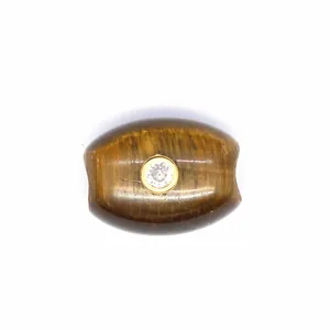 Close-up of natural tiger eye barrel bead with sparkling zirconia inlay detail.