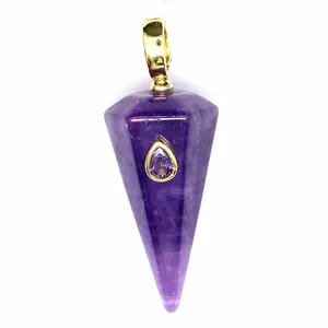 Macro view of purple hexagonal cone pendant with teardrop crystal inlay
