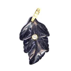 Close-up detail of blue goldstone leaf pendant with sparkling texture and central zircon