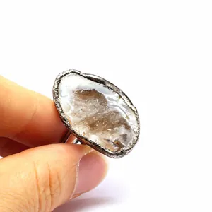 Close-up macro detail of a vintage natural druzy agate geode ring with crystal texture