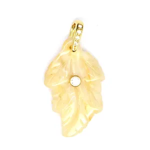 Detailed view of a small natural stone leaf pendant with sparkling zircon inlay.