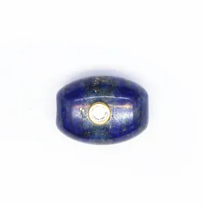 Macro view of blue natural stone barrel bead with inlaid sparkling zircon detail