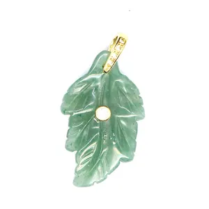 Detailed view of a green natural stone leaf pendant with gold-plated bail and zircon inlay