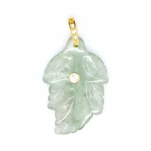 Macro view of light green natural stone leaf pendant with central zircon inlay