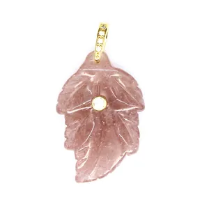 Close-up macro view of a natural stone leaf pendant with elegant gold and zircon inlay