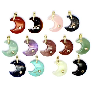 Detailed view of assorted natural gemstone crescent moon pendants with gold bails