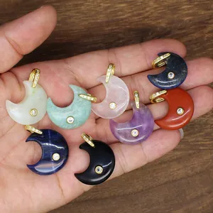Close-up detail of assorted natural stone moon pendants with gold zircon-encrusted bails