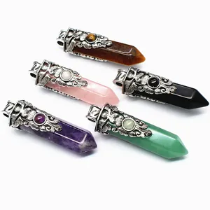 Close-up detail of vintage carved flower caps on various hexagonal crystal pillar pendants