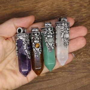 Macro view of assorted natural stone hexagonal crystal pendants with vintage floral caps