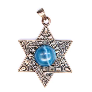 Détail d'un pendentif hexagramme en bronze vintage avec une pierre œil de chat bleu.