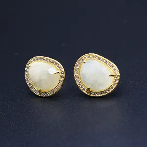 Detail view of baroque gold-plated stud earrings with sunstone and micro-pave crystals
