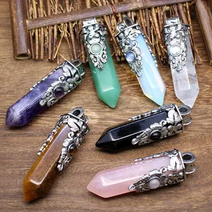 Assortment of vintage carved hexagonal natural stone pendants on a wooden surface
