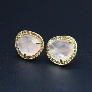 Detail of faceted rose quartz stud earrings with micro-paved crystals and gold plating