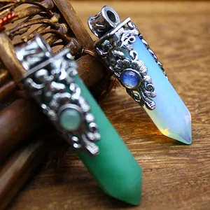 Detail of vintage-style natural stone hexagonal crystal point pendants with floral metal caps.