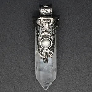 Macro detail of vintage floral silver carving on a clear crystal hexagonal pendant