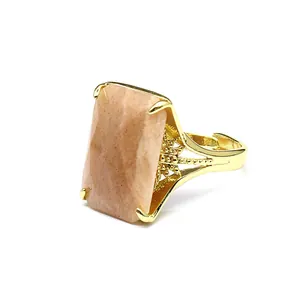 Macro detail of a rectangular faceted sunstone set in an elegant gold adjustable ring