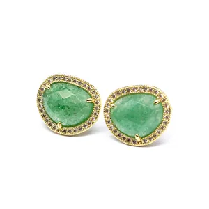 Detailed view of baroque style green stone stud earrings with micro-pave crystal halo