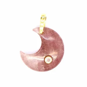 Detail of natural purple stone moon pendant with sparkling zircon inlay and gold bail