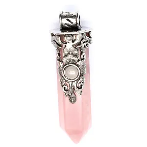 Macro detail of natural rose quartz hexagonal point pendant with silver filigree cap