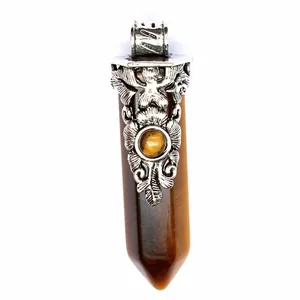 Detailed close-up of vintage tiger's eye crystal hexagonal column pendant with floral metal cap