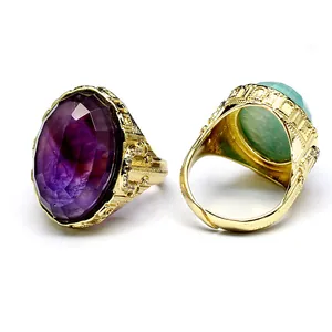 Close-up of vintage gold adjustable rings with oval faceted amethyst and amazonite stones