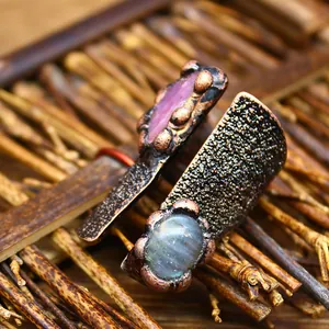 Close-up of vintage medieval style open ring with natural labradorite and ruby stones