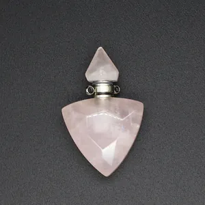 Detailed macro shot of a faceted rose quartz triangular essential oil bottle pendant
