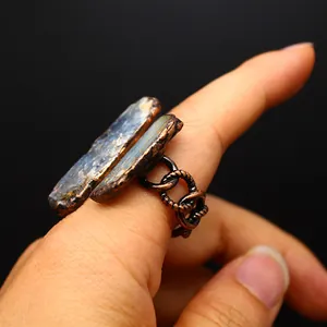 Macro detail of a vintage medieval-style adjustable ring with natural raw blue stone