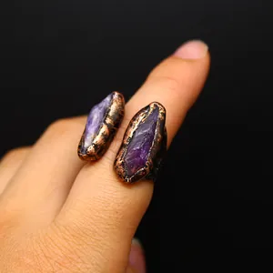 Macro view of unique vintage style ring featuring raw purple amethyst stones in a copper setting