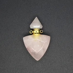 Detailed close-up view of triangular rose quartz crystal essential oil bottle pendant