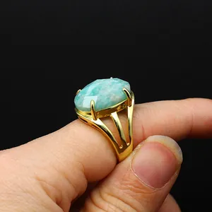 Detail of gold-plated open ring featuring a large faceted oval Amazonite stone