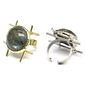 Detail view of gold and silver labradorite rings with retro medieval geometric design