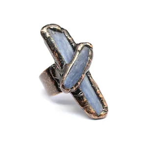 Detail view of a vintage medieval style cross ring with blue natural stones.