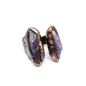 Detail of vintage raw amethyst ring with textured copper open band in medieval style.