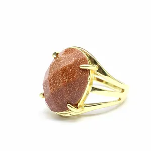 Close-up of goldstone ring with 13x18mm oval faceted stone in gold band