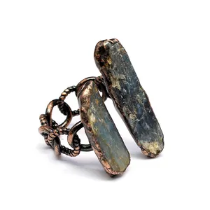 Close-up detail of a vintage medieval style copper ring featuring raw natural blue stones