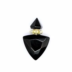Macro view of a triangular faceted black obsidian essential oil bottle pendant with gold neck