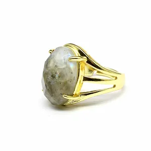 Detailed side view of a natural stone oval faceted open ring with vintage gold finish