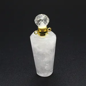 Macro view of natural white crystal perfume bottle pendant with faceted crystal cap and gold ring.