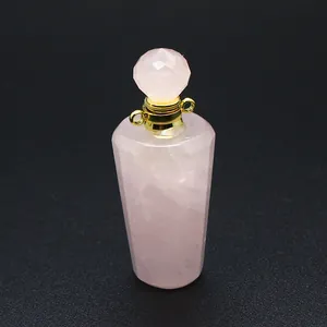 Close-up detail of a pink natural stone perfume bottle pendant with gold hardware