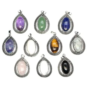 Close-up view of ten oval water-drop pendants with multi-colored gemstones in silver frames
