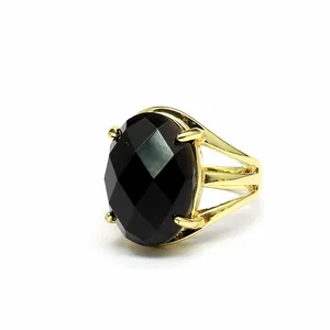 Detailed view of the 13x18mm oval faceted black stone on a vintage gold open ring