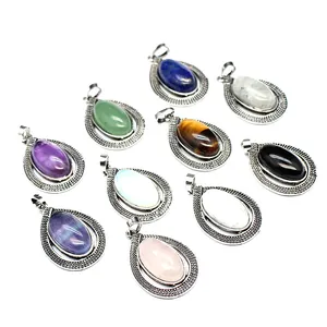A collection of various oval crystal pendants in decorative teardrop metal frames