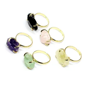 Collection of five colorful natural raw crystal rings with adjustable gold-plated bands.